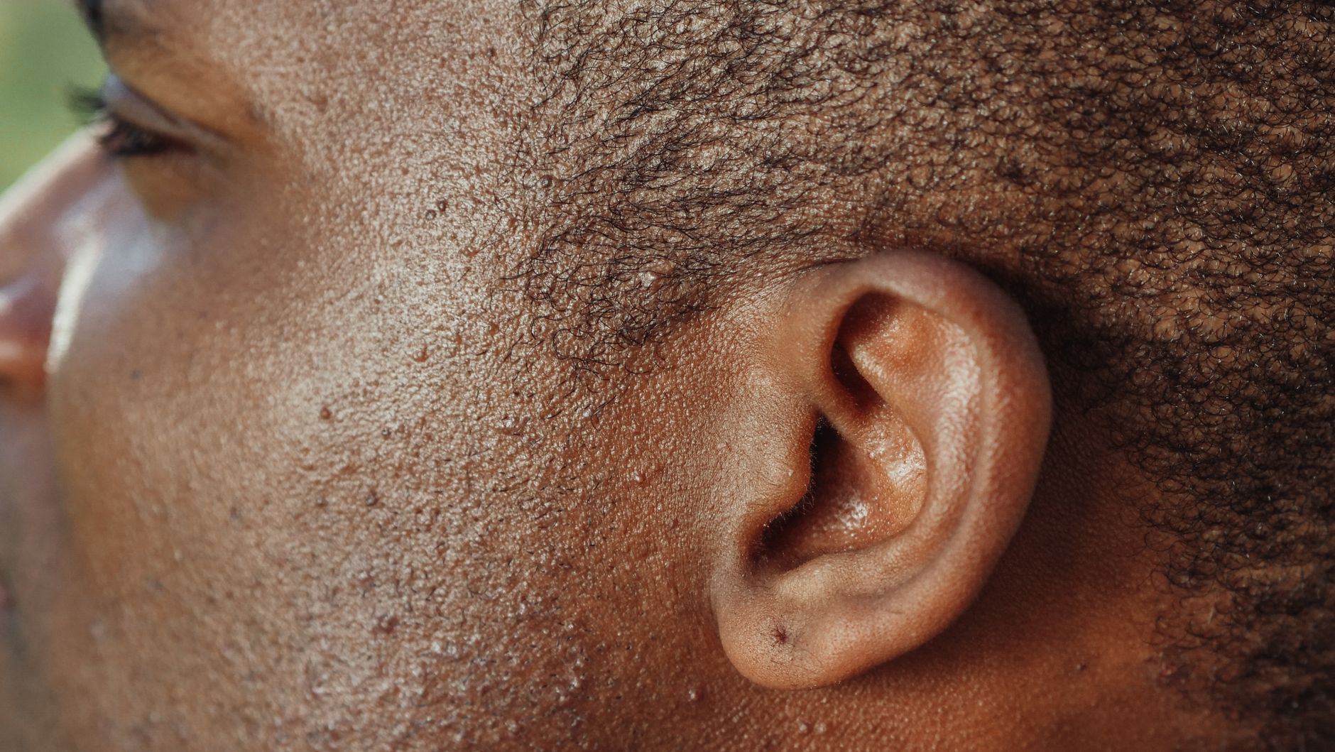 Detailed close-up image highlighting the texture of human skin and ear.
